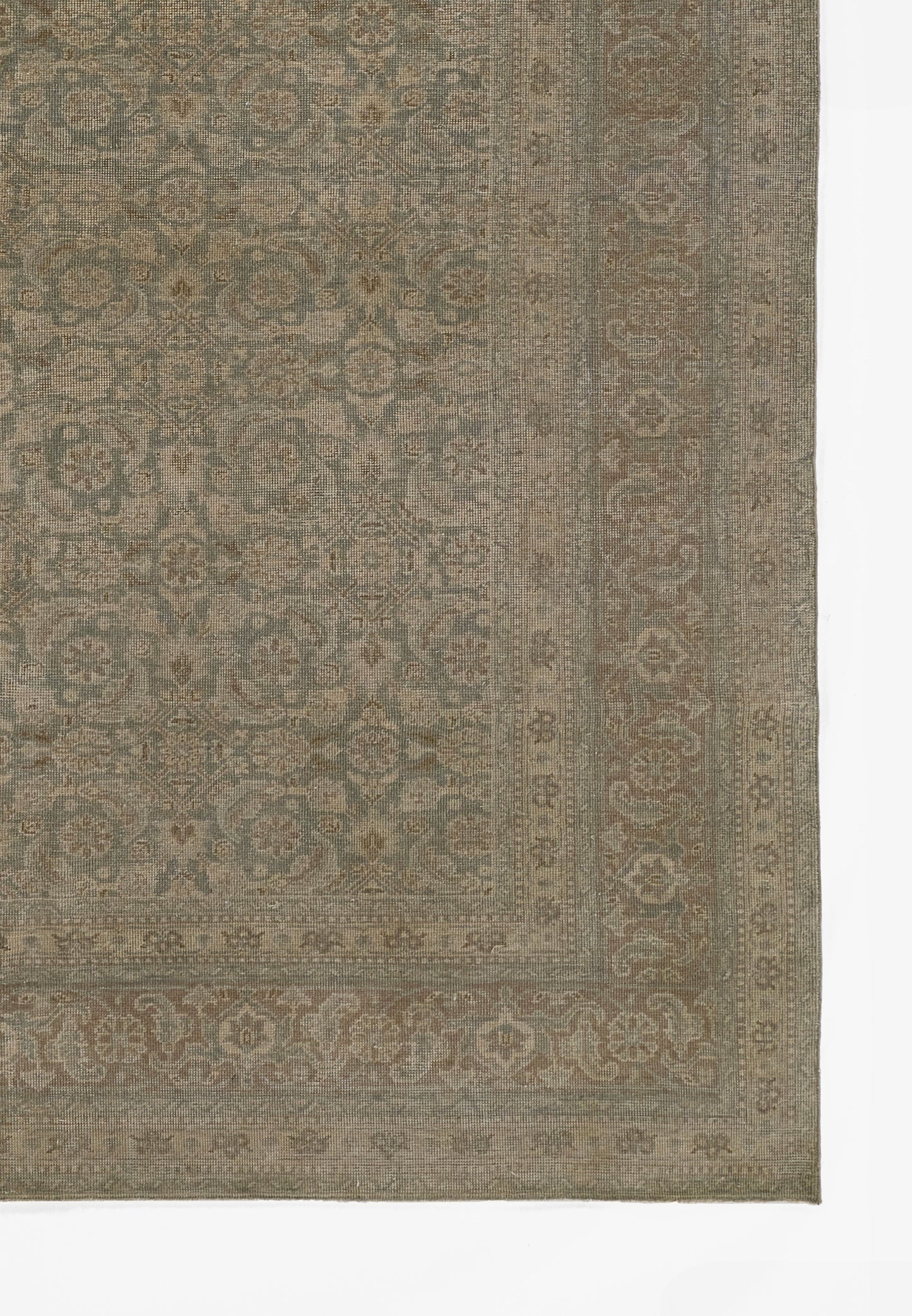 Muted blue-gray oriental rug with floral medallion pattern and decorative border in earthy tones.