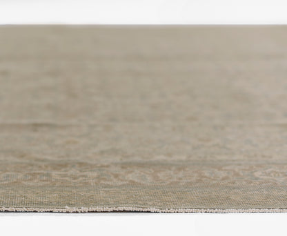 Beige woven runner rug with subtle pattern and white fringe along its edge.