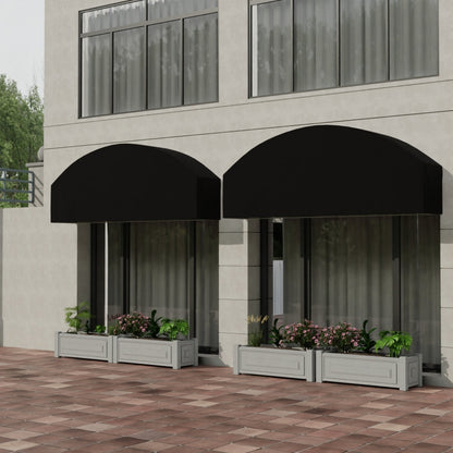 Two black curved awnings over glass storefronts; planter boxes with green plants and pink flowers on a brick patio.