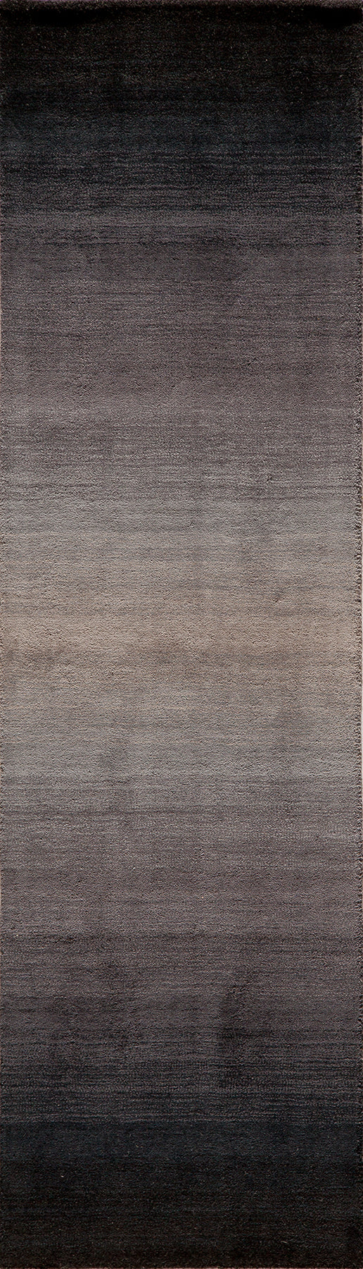 Gradient rectangular rug fading from black at the top to warm taupe at the bottom, plush texture.