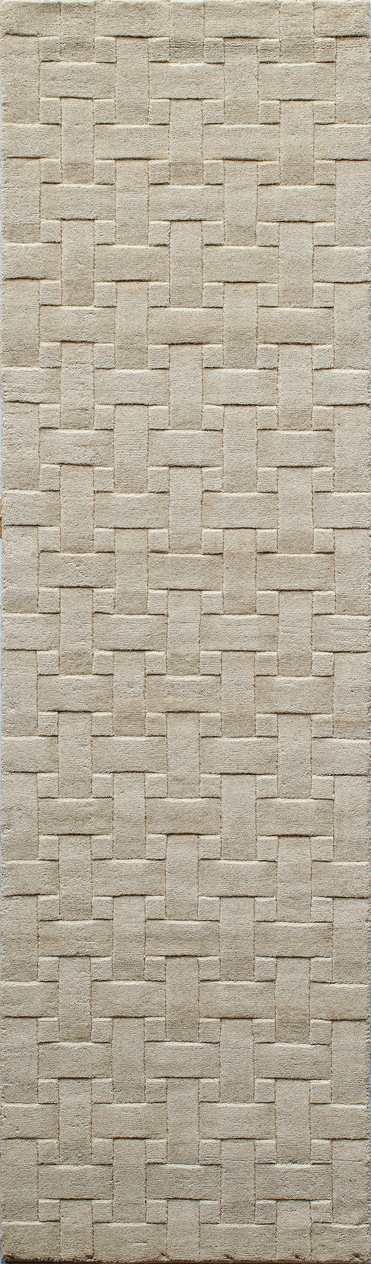 Beige woven runner rug with an interlocking rectangular basket-weave pattern and soft textured surface, 2' x 8'.