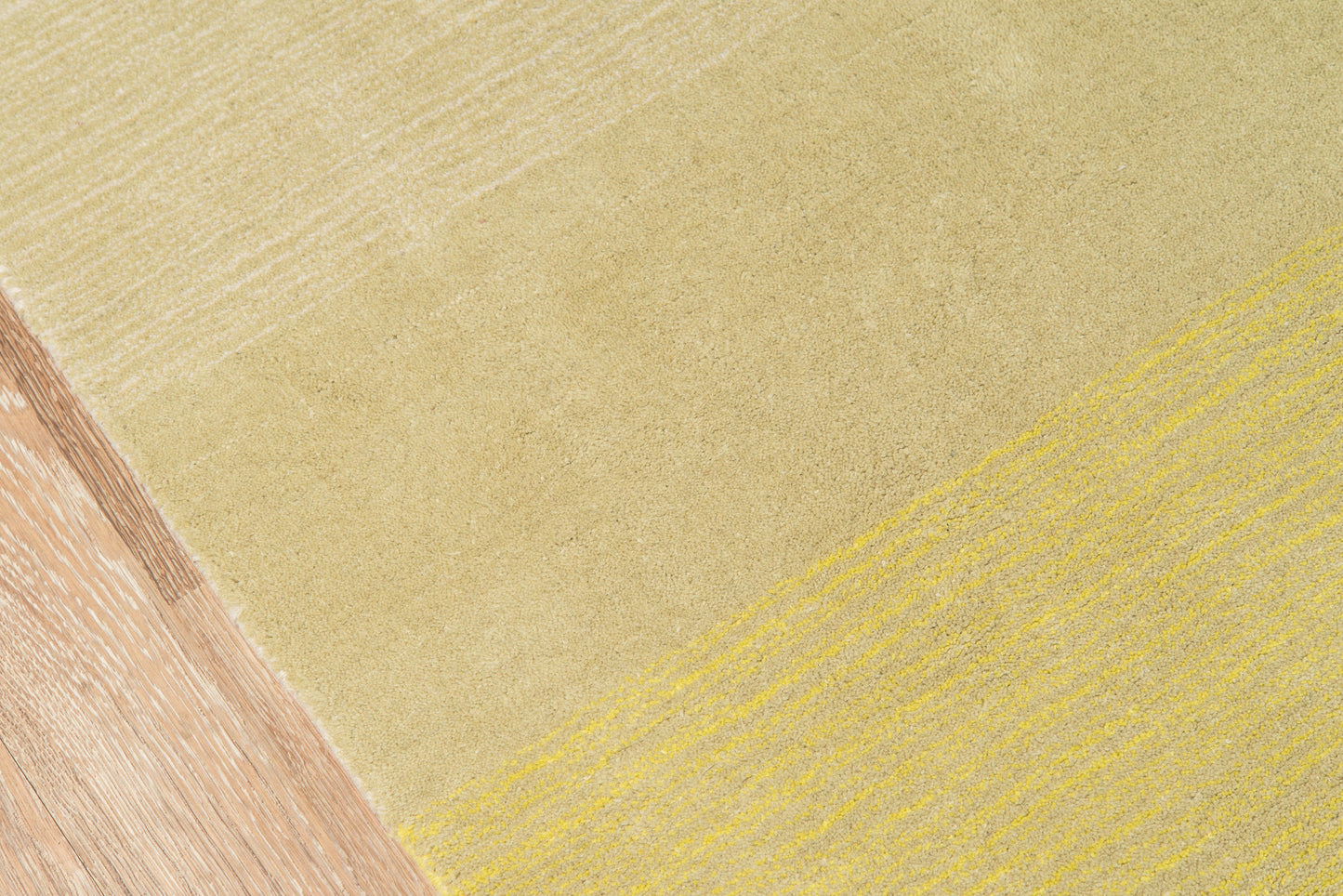 Abstract tri-tone pattern with sandy beige field, mustard-yellow diagonal stripe, and light brown wood texture.