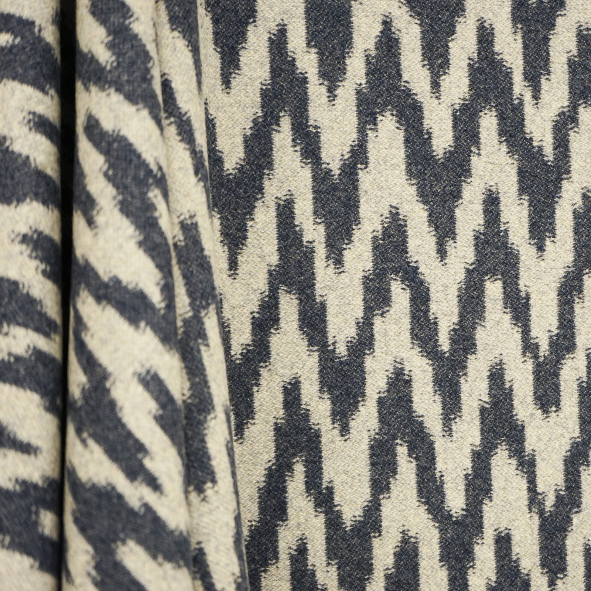 Blue ikat jacquard wool fabric with a bold zigzag pattern; versatile upholstery or throw textile.