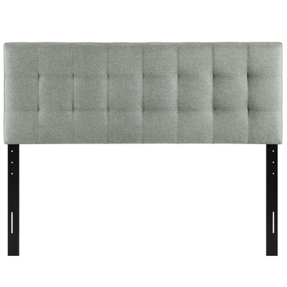 Gray tufted fabric headboard with square grid pattern, mounted on black metal legs for bed frame.