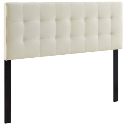 White tufted upholstered headboard with square quilted panels on black metal legs.