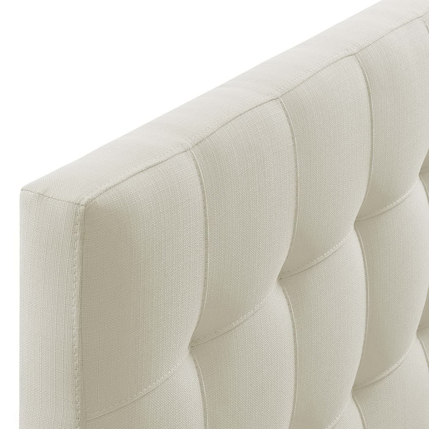 Ivory tufted fabric with grid-square panels on a modern headboard.