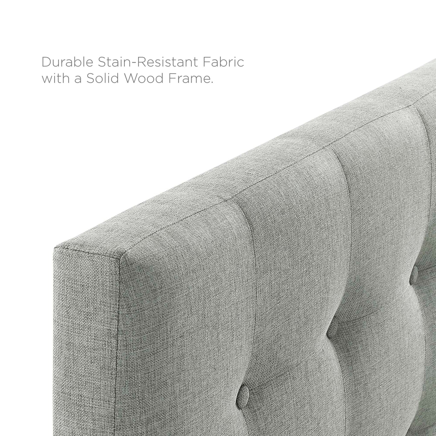 Grey upholstered fabric headboard with vertical button-tufted panels and a soft textured weave.