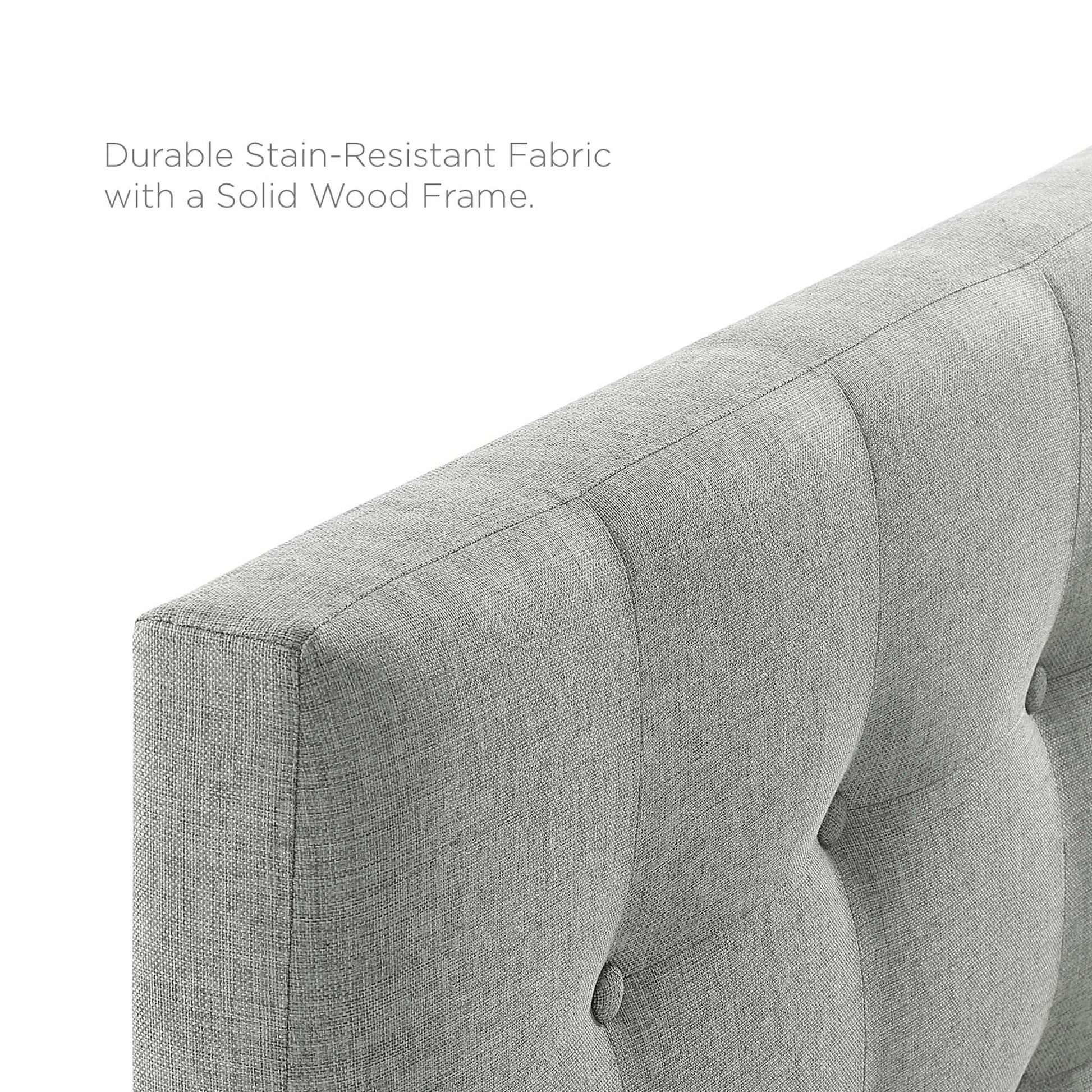 Grey upholstered fabric headboard with vertical button-tufted panels and a soft textured weave.