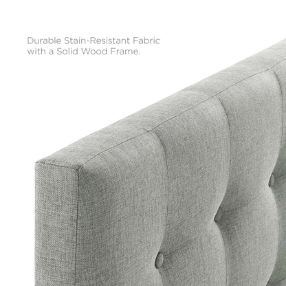 Grey upholstered fabric headboard with vertical button-tufted panels and a soft textured weave.