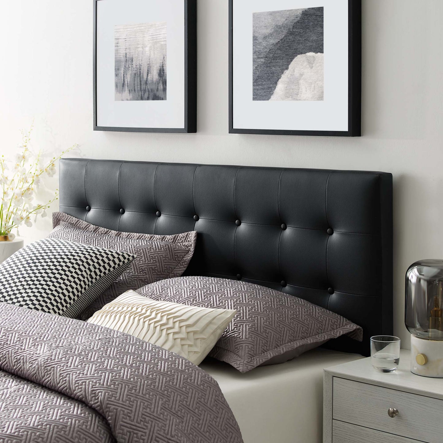 Black tufted vinyl king headboard with button details.
