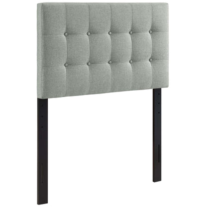 Grey fabric tufted twin headboard with square button tufts & black metal legs.