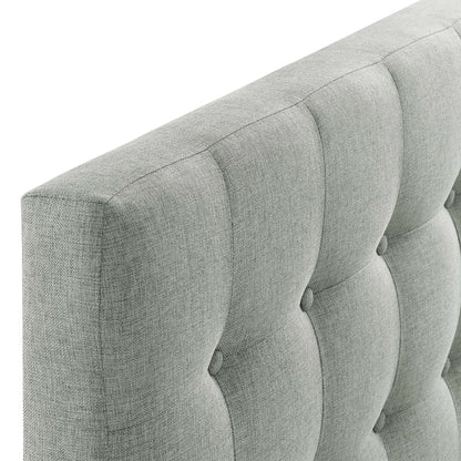 Grey tufted fabric twin headboard with vertical channels and button tufting.
