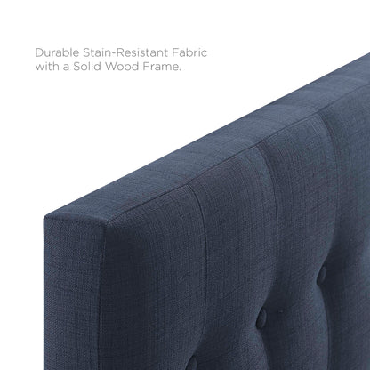 Navy blue tufted fabric twin headboard with channel stitching and button accents; wood frame.