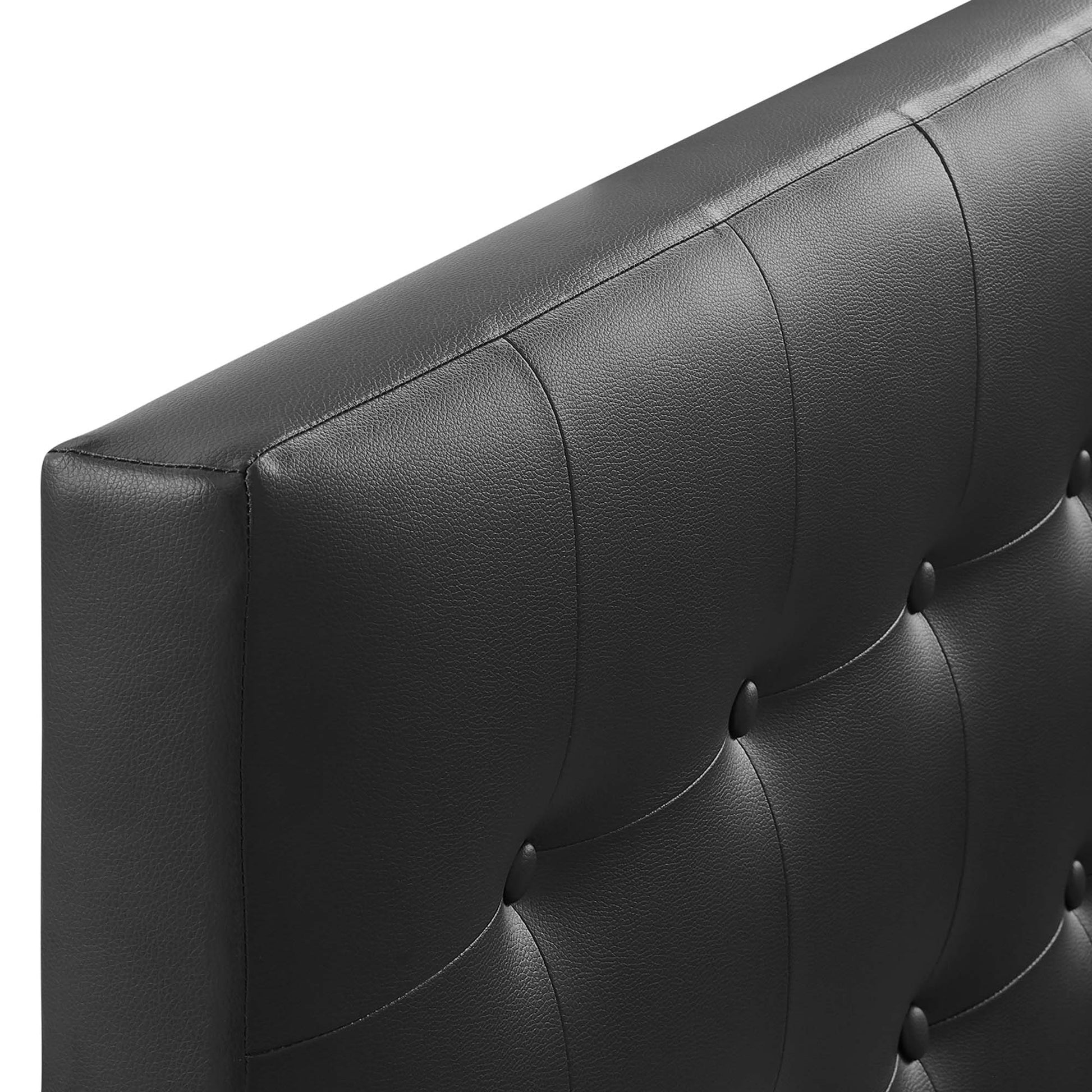 Black upholstered vinyl twin headboard with tufted button-tuck detail and vertical channels.
