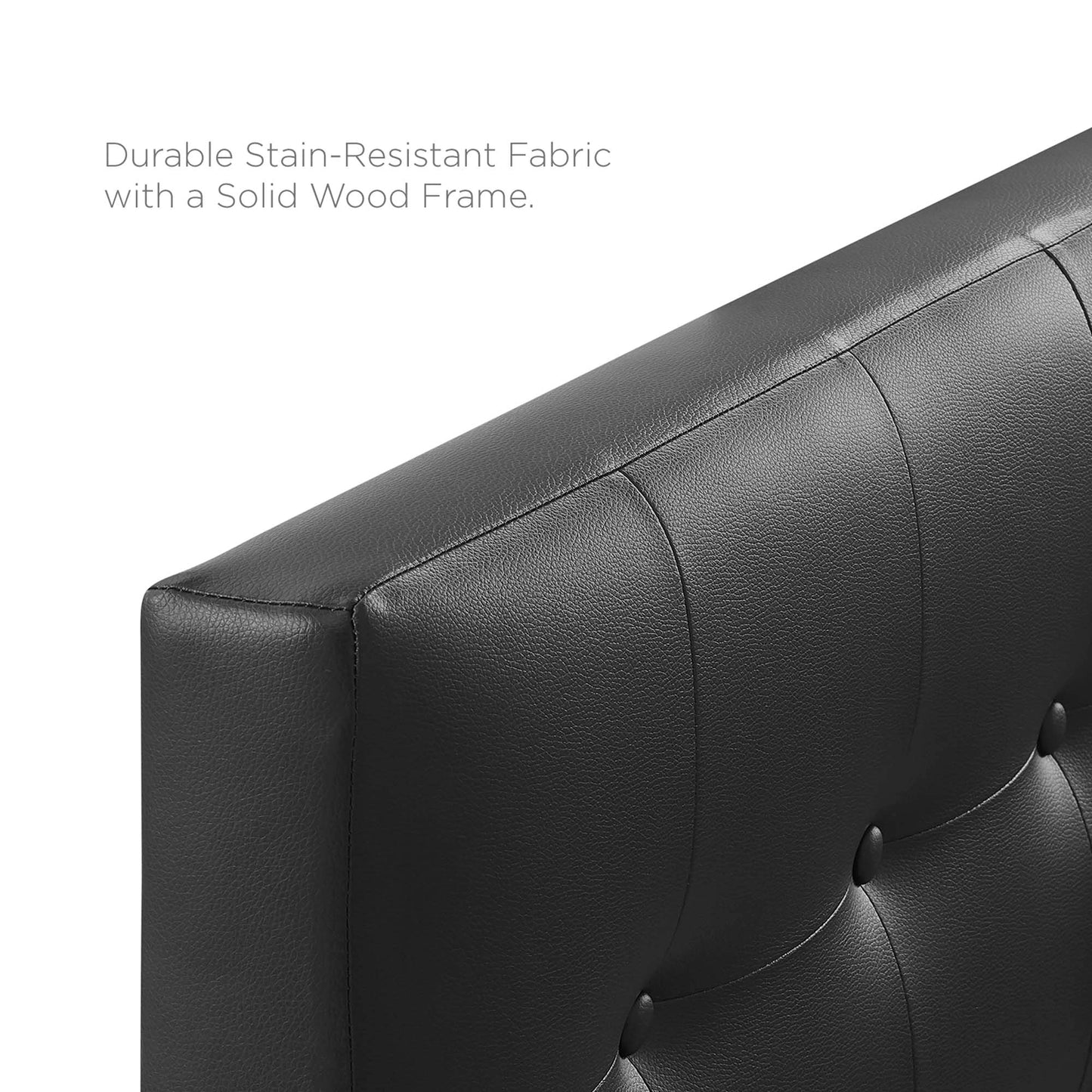 Black tufted vinyl twin headboard with vertical channel seams and button tufting.