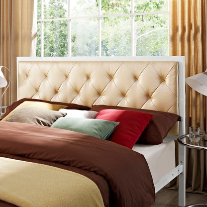 Beige tufted headboard bed with white frame, brown duvet, and multicolor throw pillows in a sunlit bedroom.