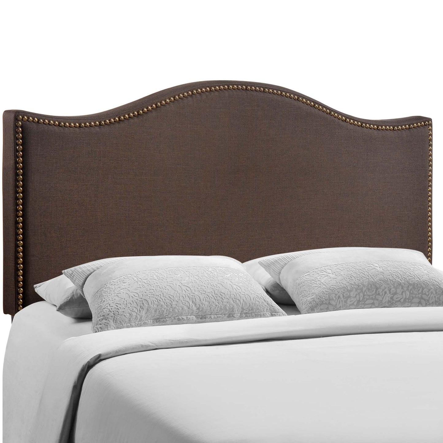 Dark brown upholstered headboard with curved top and brass nailhead trim, white bedding and two pillows.