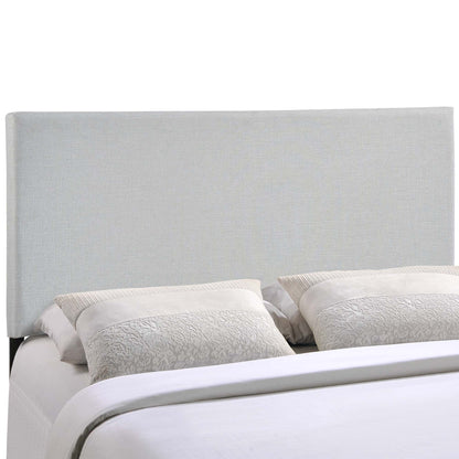 Gray upholstered headboard with two textured light-gray pillows atop white bedding.