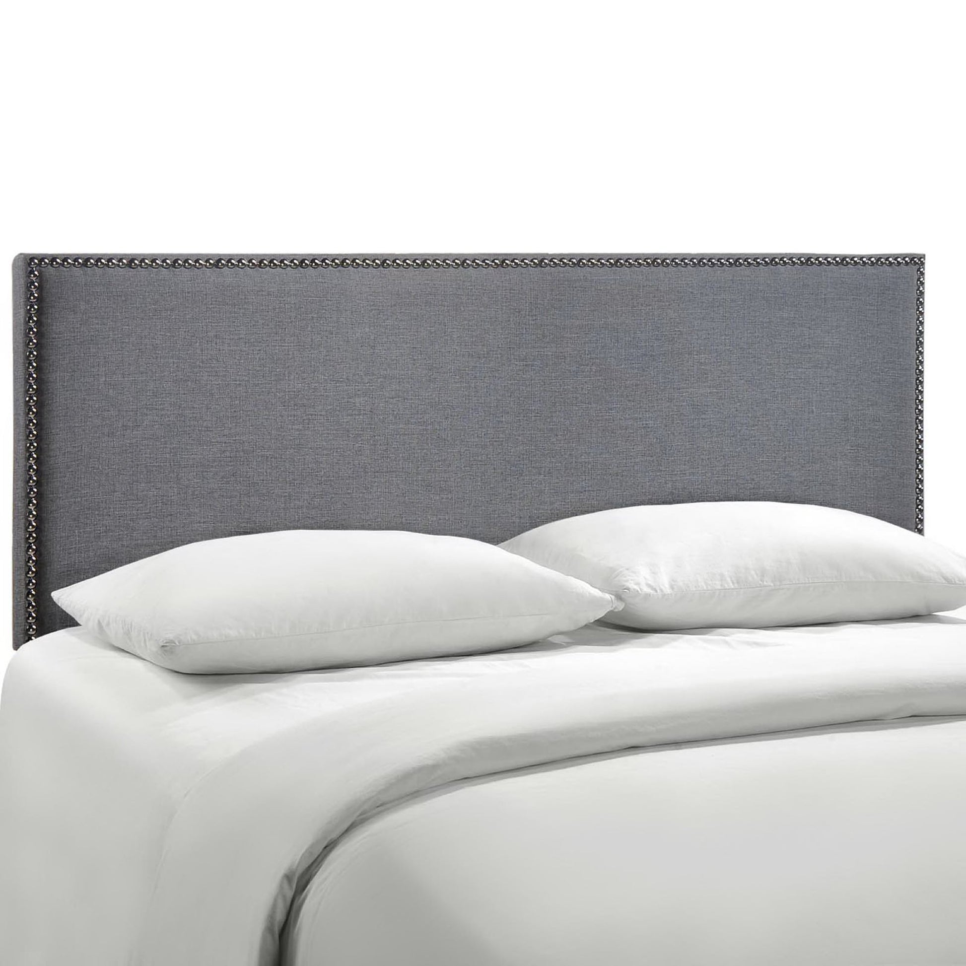 Black fabric upholstered queen headboard with nailhead trim above white bedding and pillows on a modern bed.