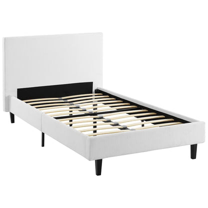 White upholstered platform bed with padded headboard, black legs, and slatted wood base.