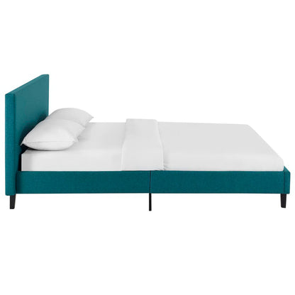 Teal upholstered platform bed with tall headboard, white bedding, slim black legs, modern minimalist design.