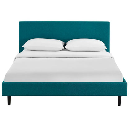Teal fabric full bed with tall upholstered headboard, white bedding and two pillows; modern minimalist bedroom furniture.