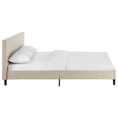 Beige upholstered platform bed with headboard, white bedding and slim black legs.