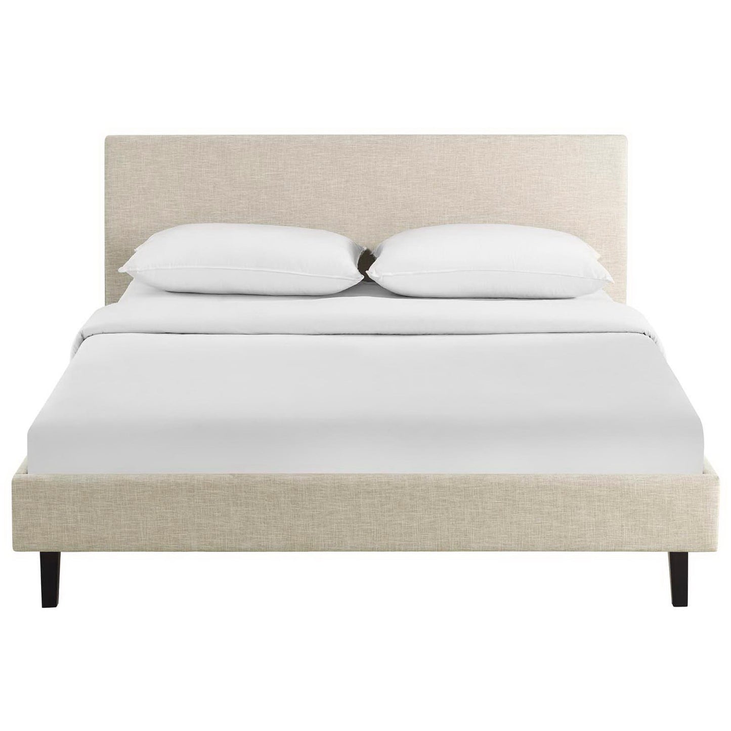 Brown fabric upholstered platform bed with tall headboard, white sheets and two pillows, black tapered legs.