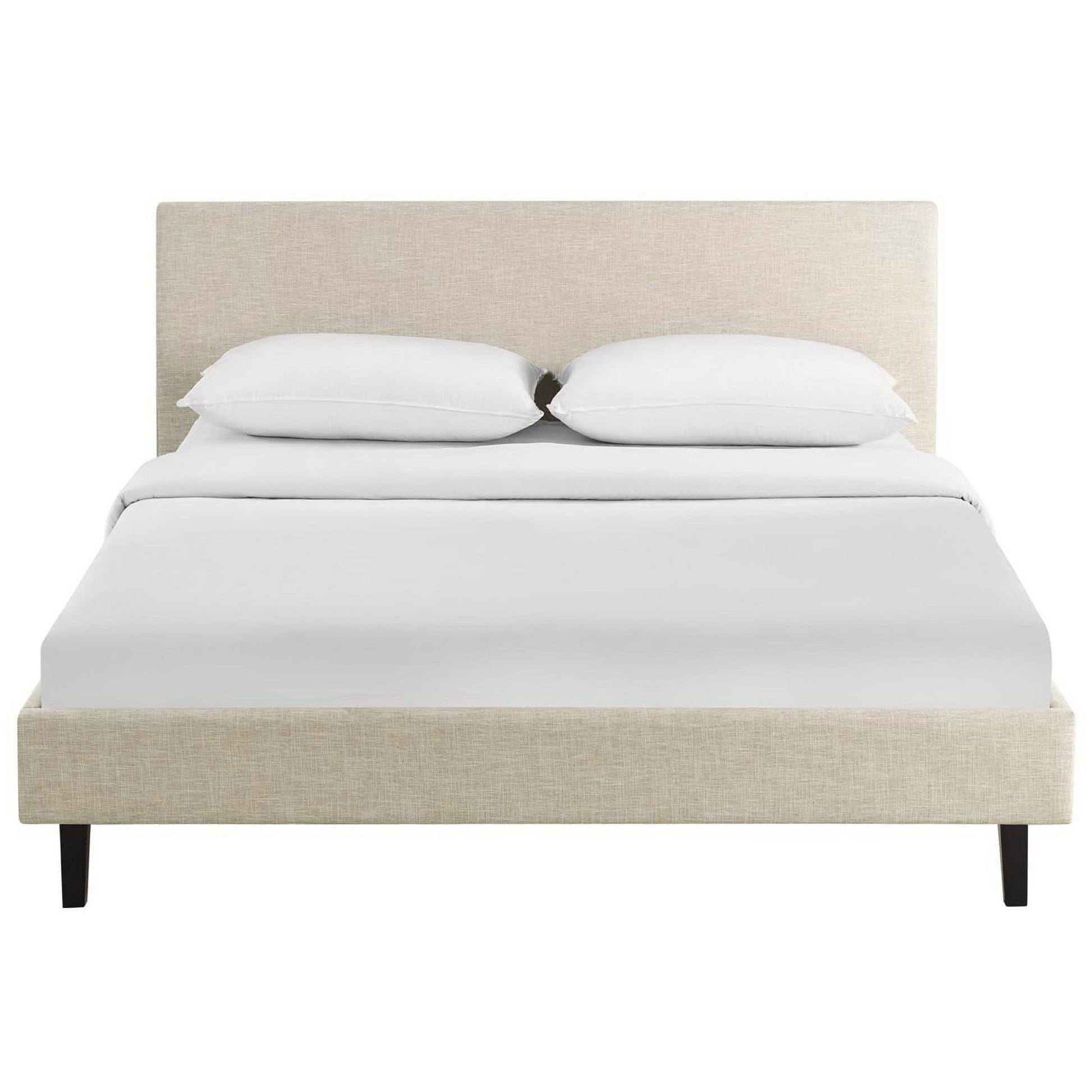 Brown fabric upholstered platform bed with tall headboard, white sheets and two pillows, black tapered legs.
