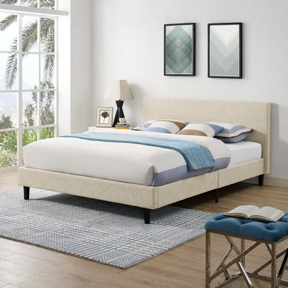 Brown upholstered platform bed with white/blue bedding and blue throw; nightstand lamp, art, blue tufted bench.