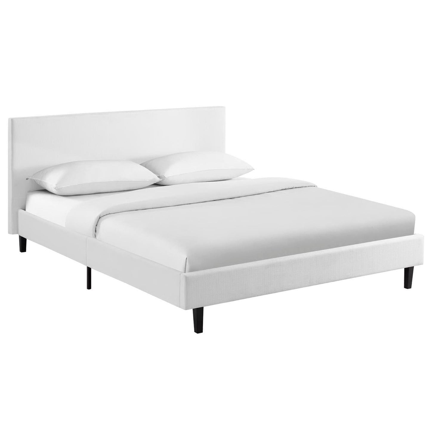 White upholstered platform bed with tall headboard and black legs, dressed in white linens