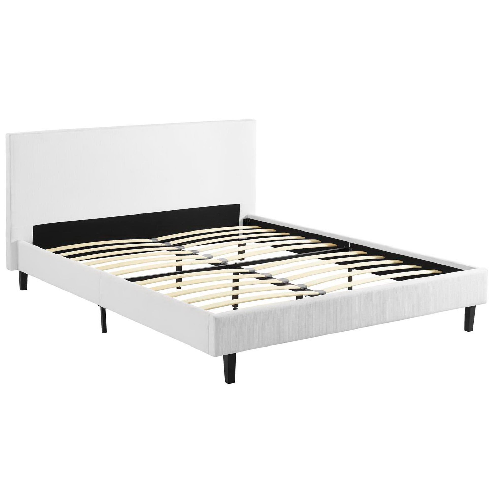 White upholstered platform bed & black inset headboard, slatted wooden base & black tapered legs.