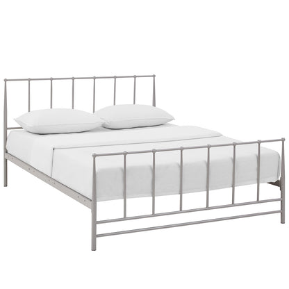 Grey metal bed frame with vertical bars and low footboard, dressed with white bedding and pillows.