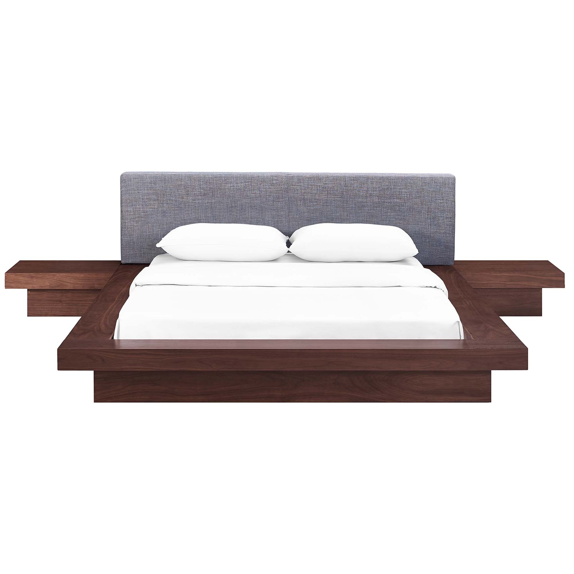 Walnut platform bed with gray upholstered headboard and built-in side tables, white bedding.