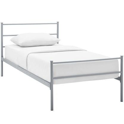 Light gray metal twin bed frame with horizontal bar headboard and footboard, white bedding.