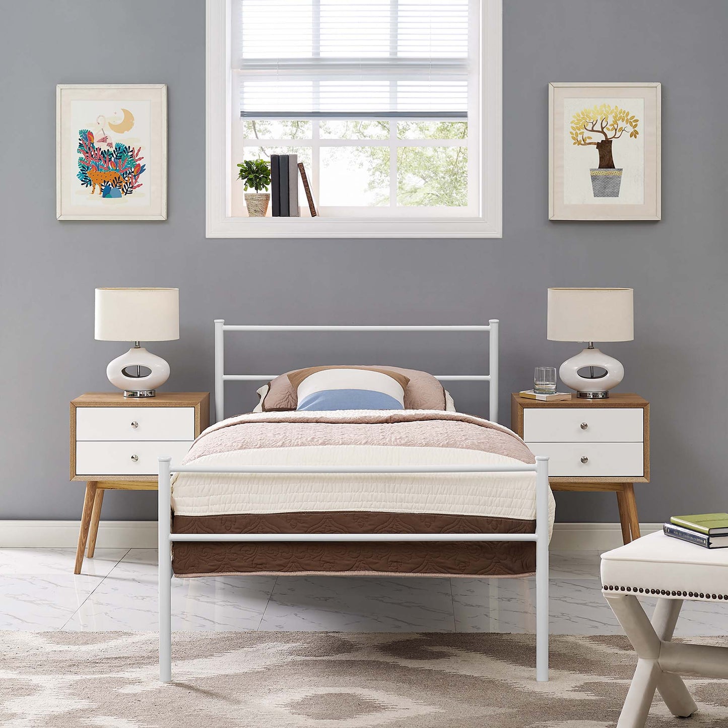 White metal bed frame with beige quilt and brown bed skirt, two wood-and-white drawer nightstands, and matching lamps on gray walls.