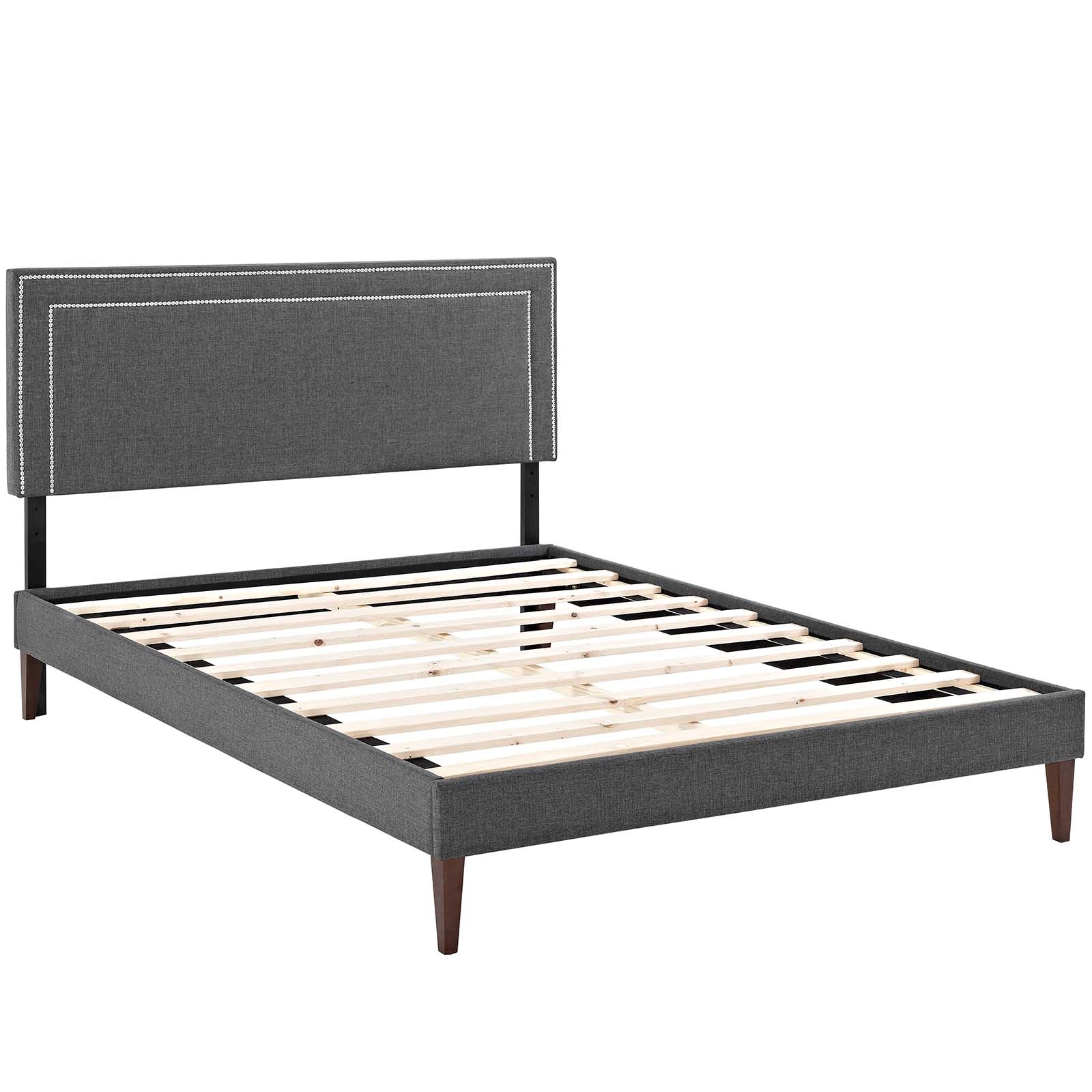 Gray fabric upholstered platform bed with padded headboard, wooden slats, tapered legs; modern minimalist style.