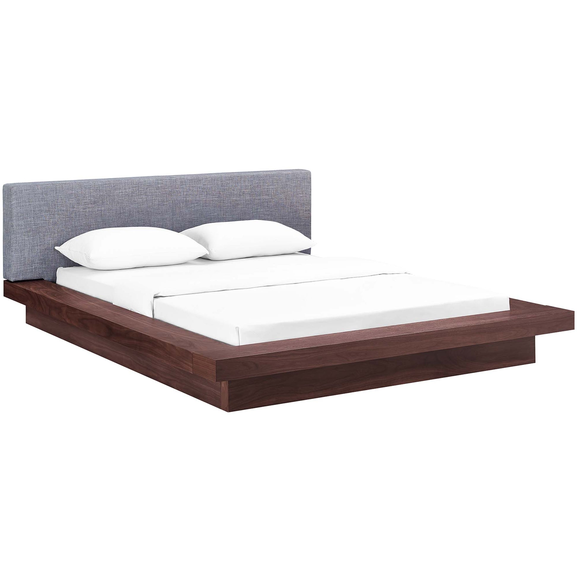Gray fabric upholstered headboard on a low-profile queen platform bed with white bedding.