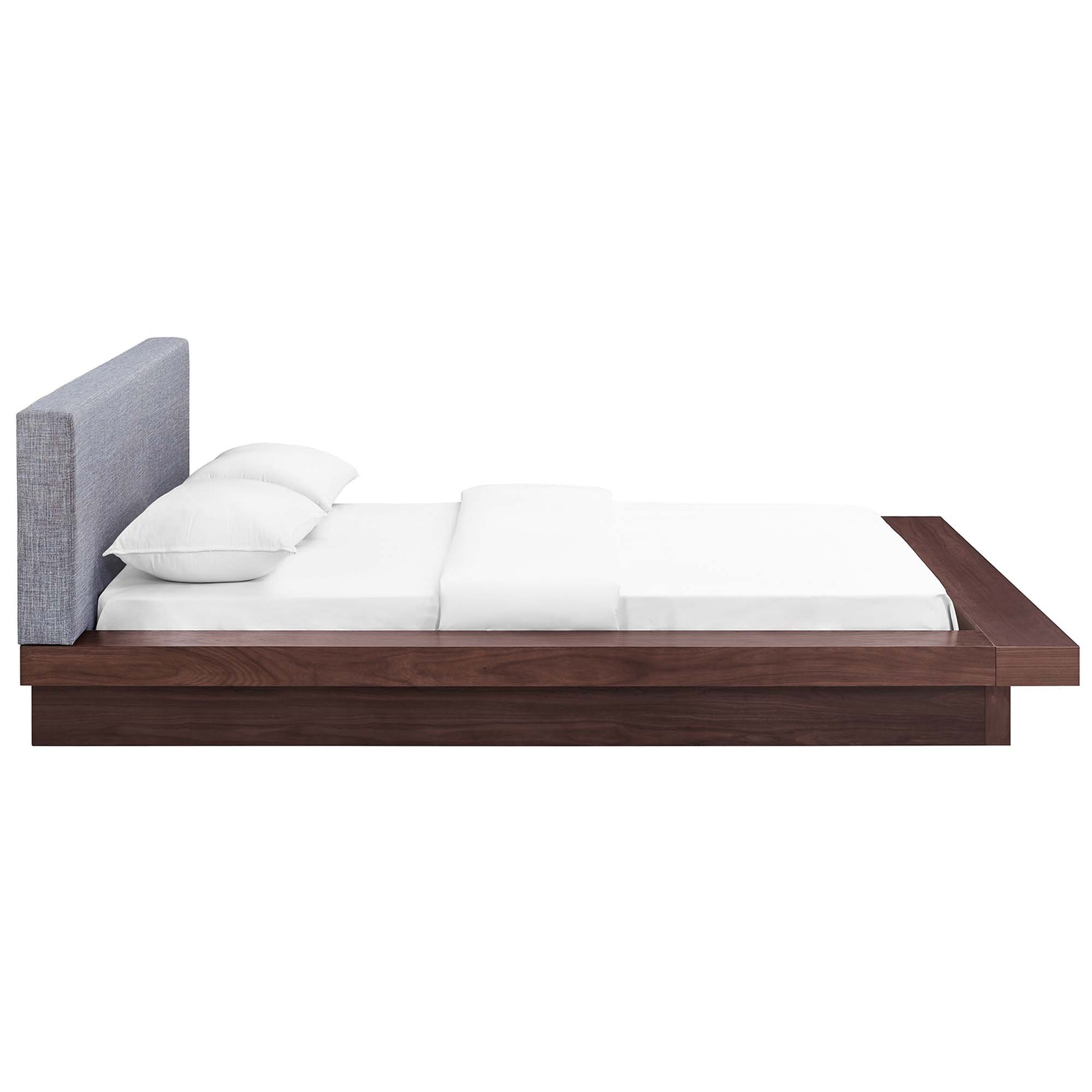 Gray fabric queen platform bed with upholstered headboard and white linens, low-profile frame with built-in side shelf.