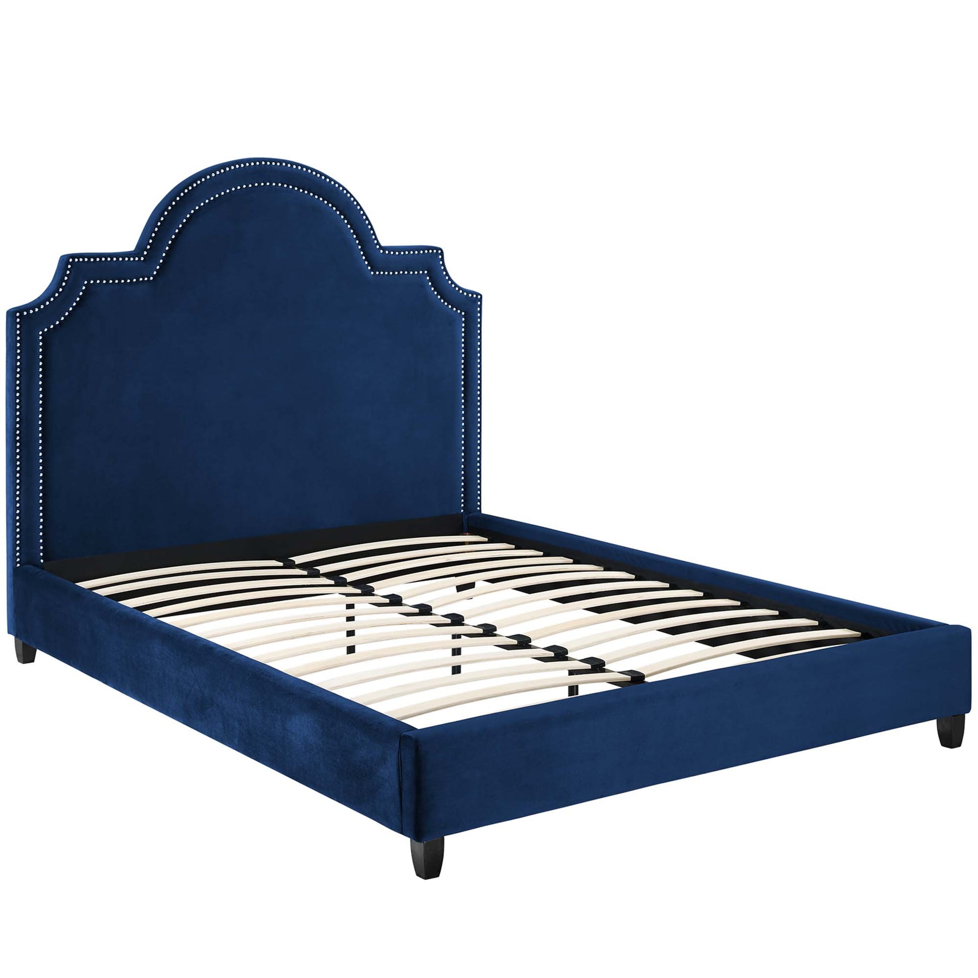 Navy blue velvet platform bed with scalloped arched headboard, nailhead trim, and slat support.