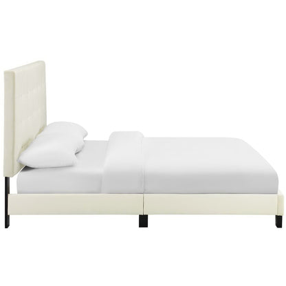 Ivory upholstered platform bed with a tall tufted headboard and white bedding.