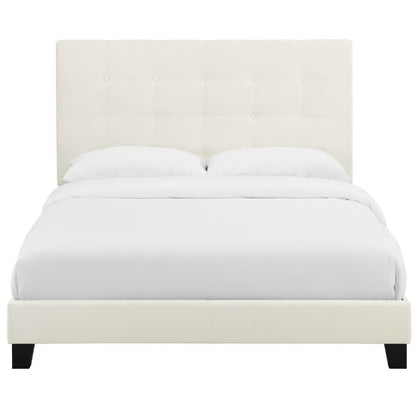 Ivory upholstered full platform bed with button-tufted headboard and white bedding.