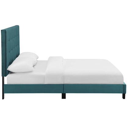 Sea blue upholstered platform bed with a tall tufted headboard, white bedding & slim black legs.