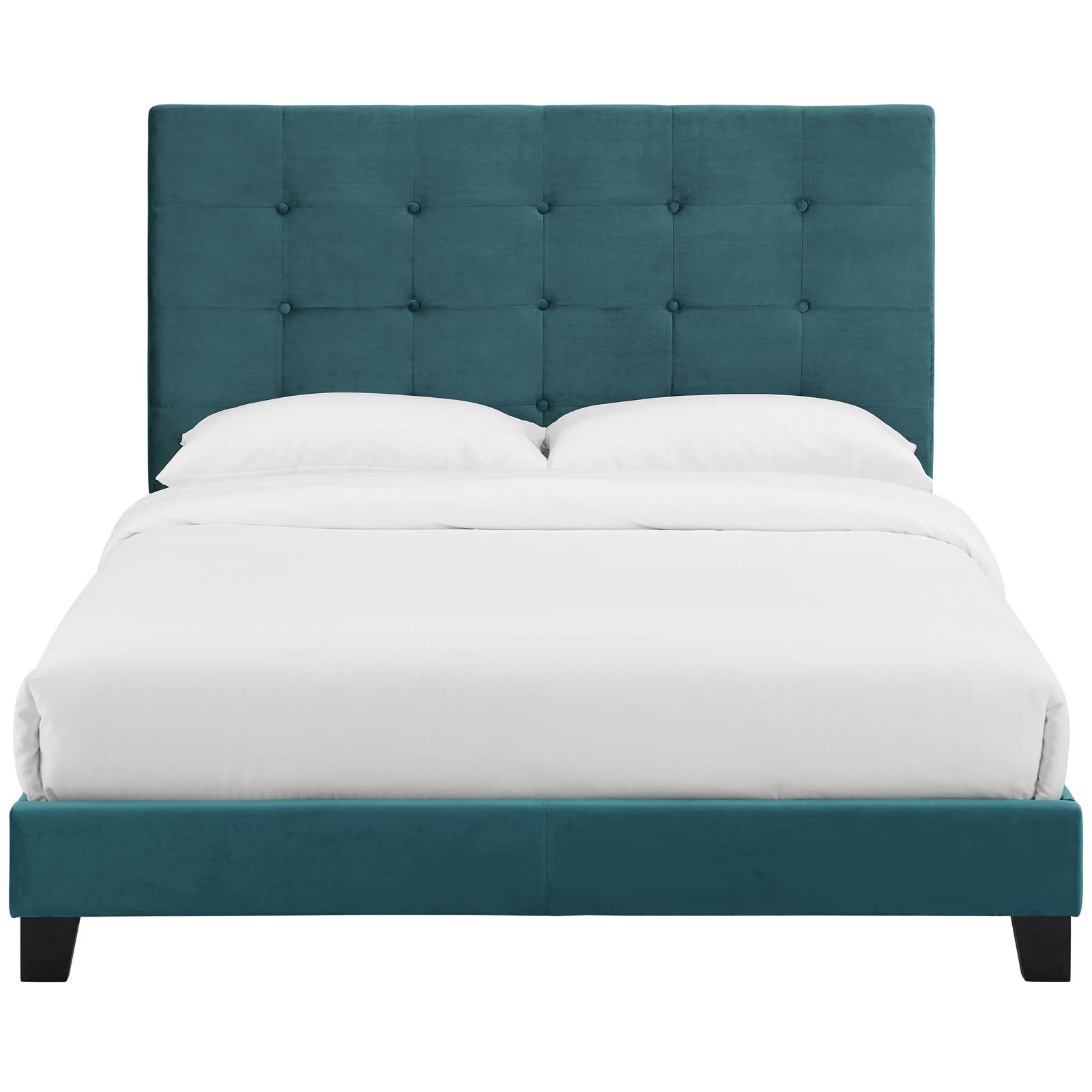 Sea blue tufted button upholstered full platform bed with a tall headboard, low rails, and dark wooden legs, dressed in white bedding.