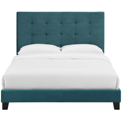 Sea blue tufted button upholstered full platform bed with a tall headboard, low rails, and dark wooden legs, dressed in white bedding.