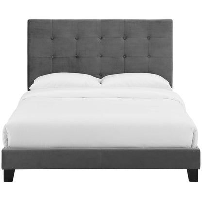 Grey fabric upholstered platform bed with a tall tufted headboard and white bedding.
