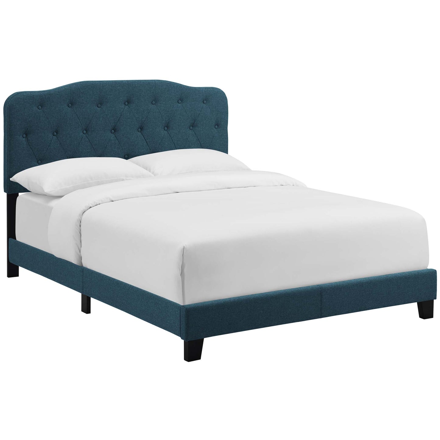 Azure upholstered platform bed with tufted curved headboard & black legs, white bedding.