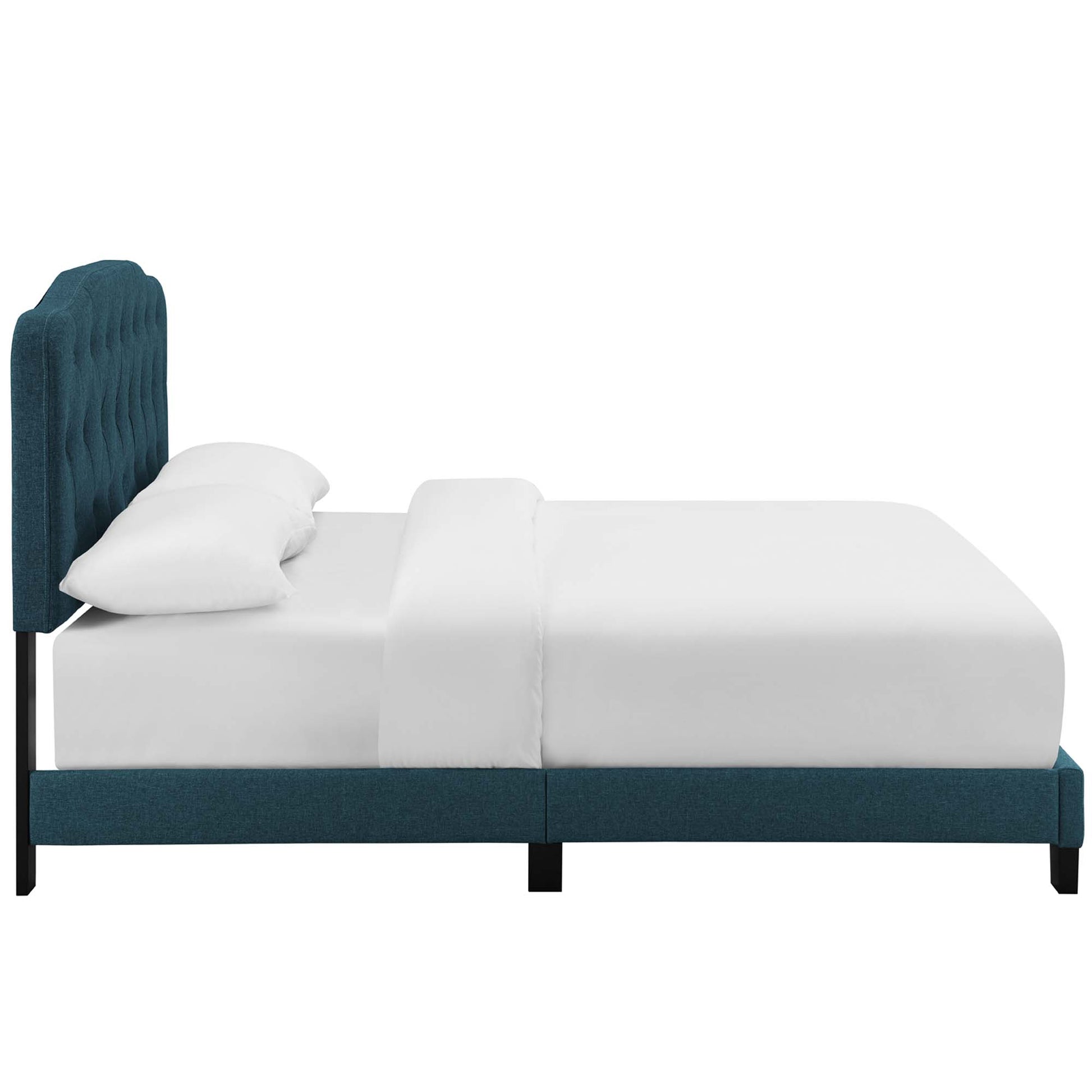 Teal upholstered platform bed with a tall tufted headboard, black legs, and white sheets and pillows.