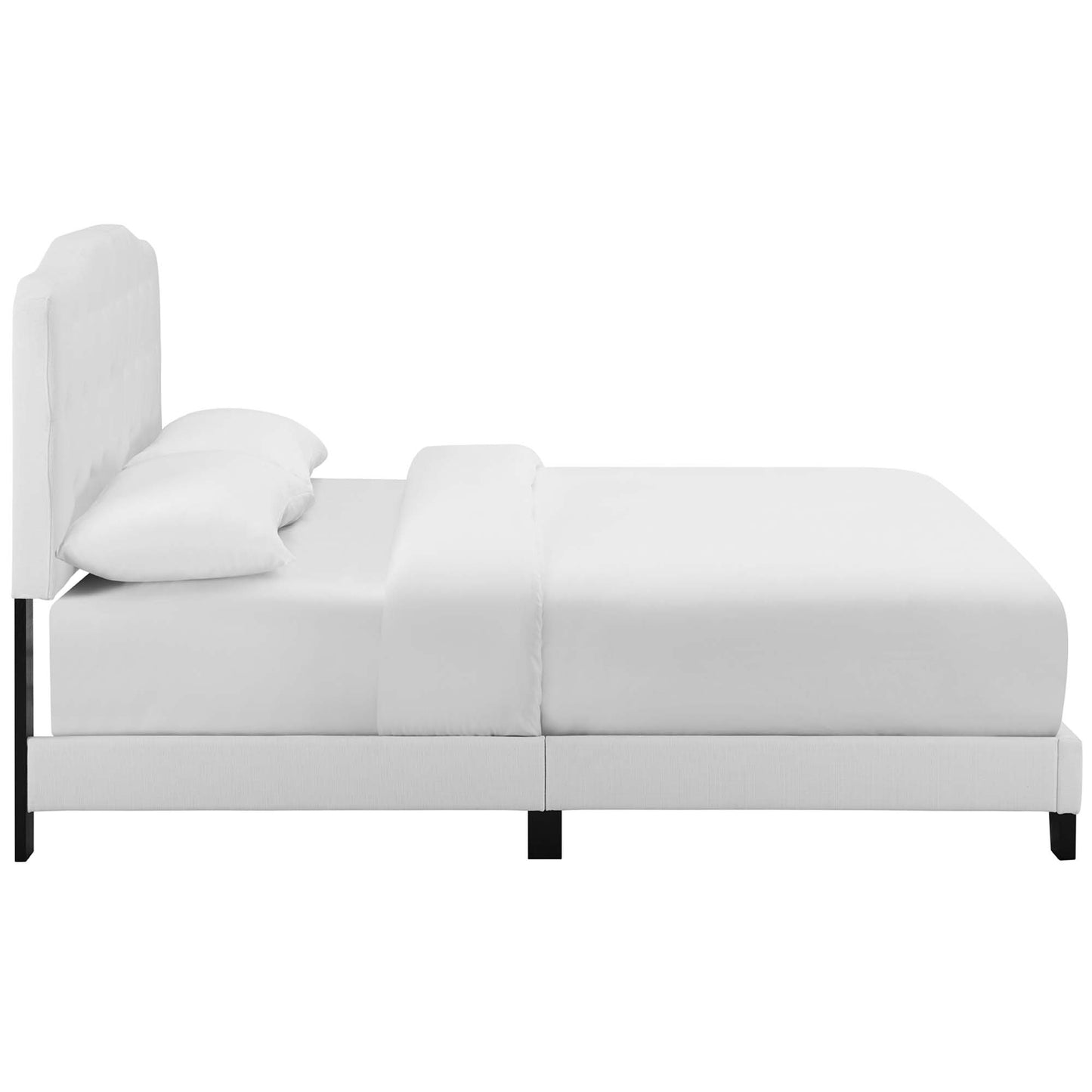 White fabric upholstered king bed with tall padded headboard, slim black legs, modern bedroom design.