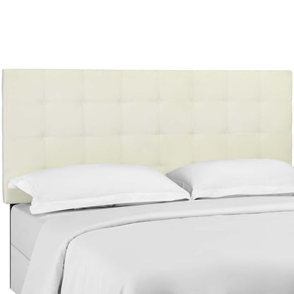 Ivory tufted headboard with square panels, white sheets and two white pillows on bed.